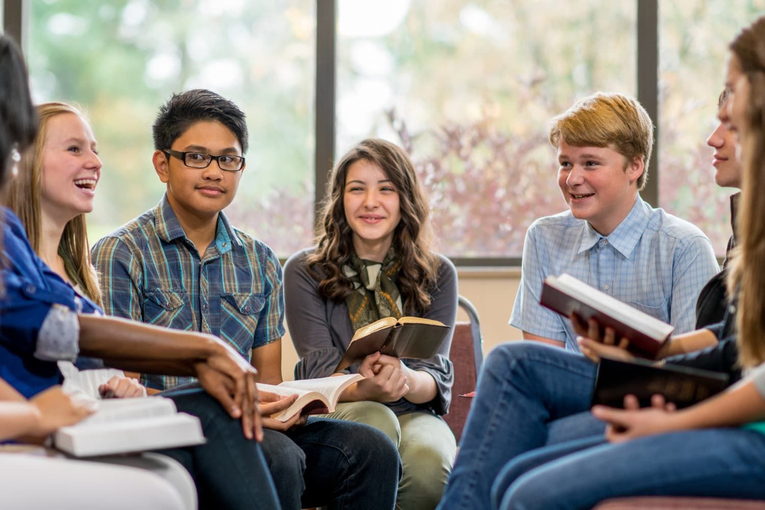 A group of teenagers studying the Bible together