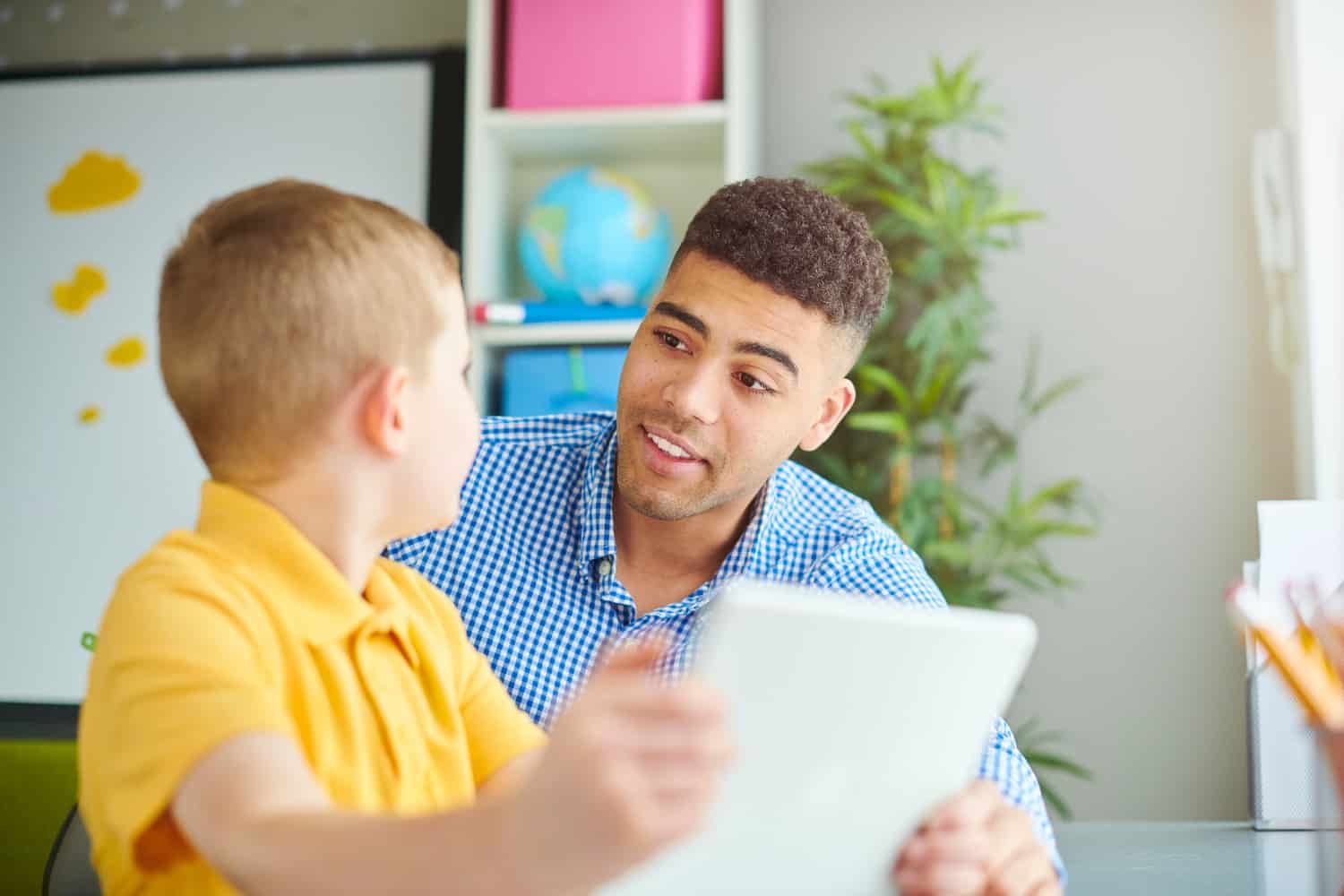 An image showing a Sunday school teacher engaged in a conversation with a young boy, Leo, illustrating the importance of understanding both verbal and non-verbal cues in children